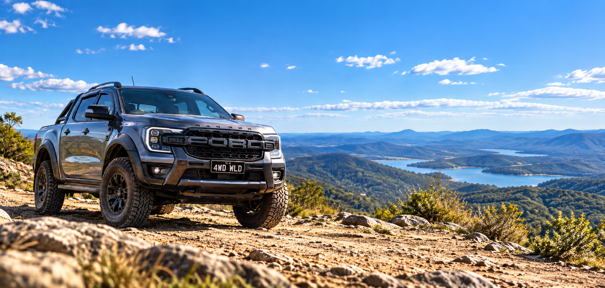 Grey Ford Ranger 4WD at a mountain lookout overlooking a lake and rugged Australian bushland.
